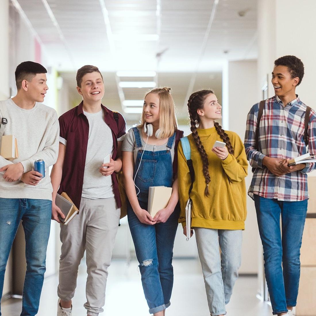 Group of high school students in school hallway.